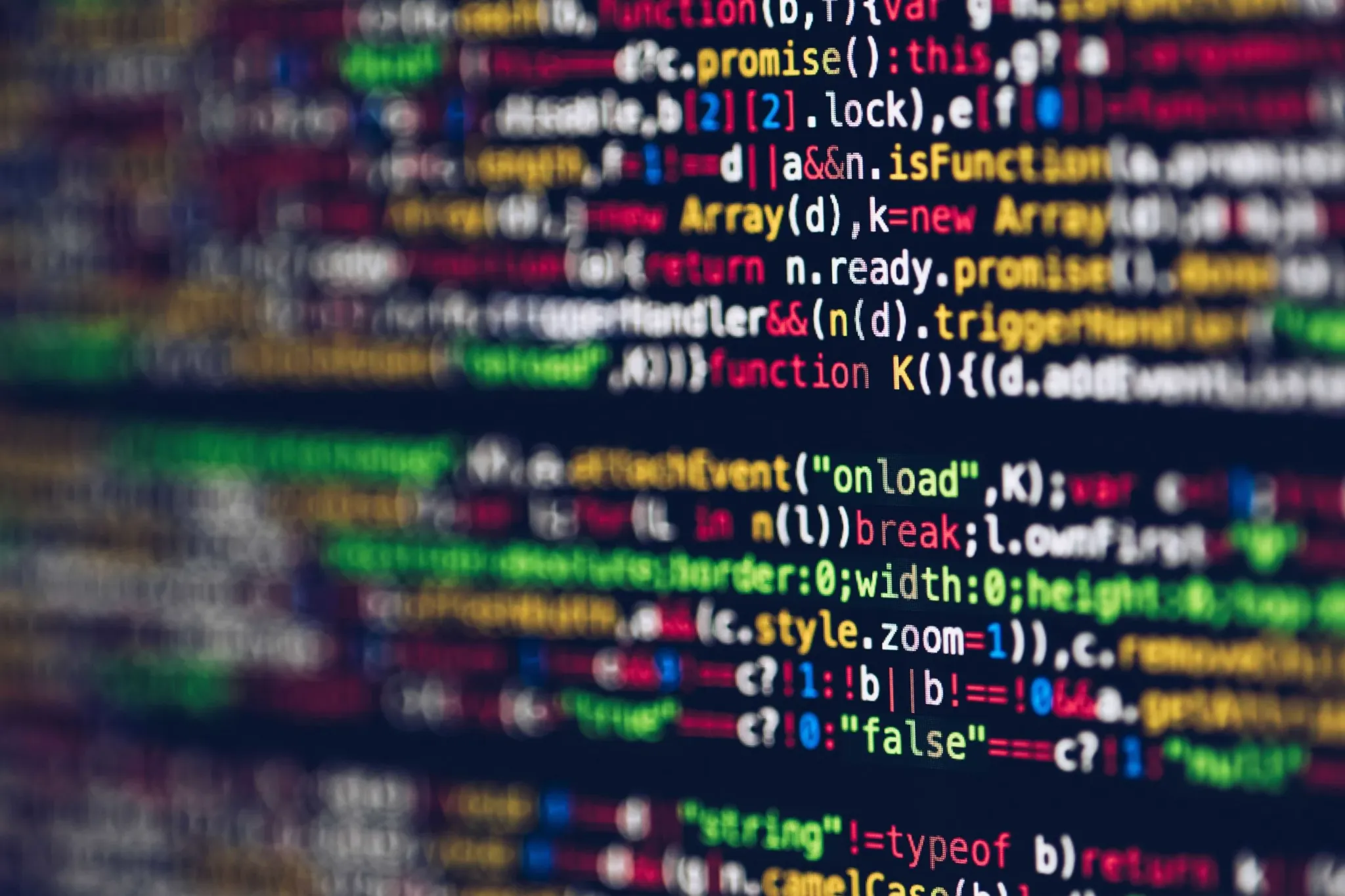 Blurry close-up of colorful computer code on a screen, highlighting software development and coding technologies.